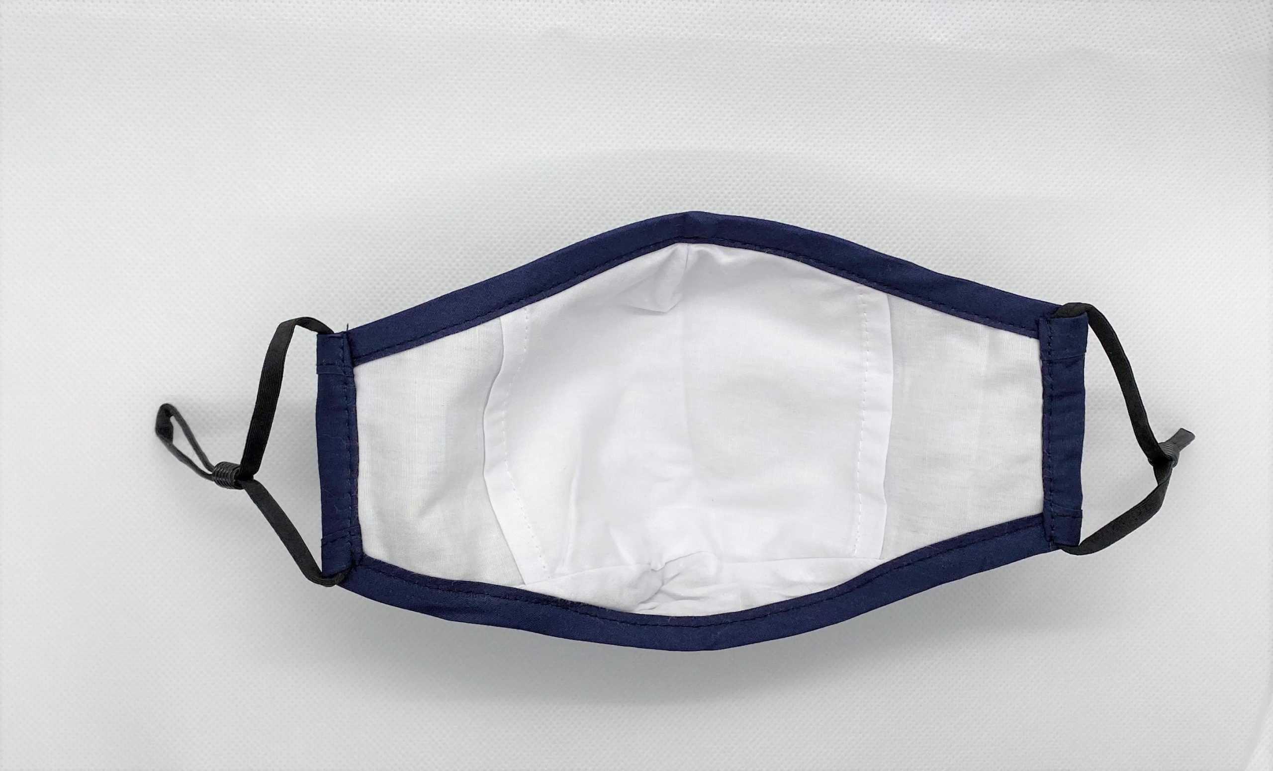 Navy blue mask with breathing valve - inner view. The valve is covered on the inside by two layers of fabric.
