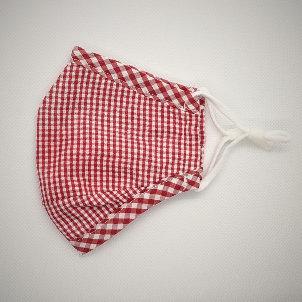 Plaid red-and-white kid's mask with metal nose clip and adjustable ear loops. Contoured nose and chin area.. Side profile view